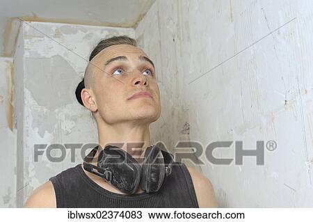 "A young man with partly shaved head looking at the done work on a construction site, refurbishment, Baden-Wuerttemberg, Germany, Europe" View Large Photo Image Stock Image - "A young man with partly shaved head looking at the done work on a construction site, refurbishment, Baden-Wuerttemberg, Germany, Europe". Fotosearch