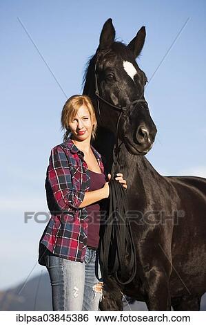 "A young woman with a black Hanoverian horse, North Tyrol, Austria, Europe" View Large Photo Image Stock Photograph - "A young woman with a black Hanoverian horse, North Tyrol, Austria, Europe". Fotosearch