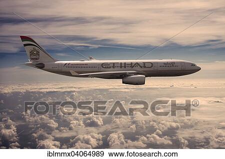 A6-EYK Etihad Airways Airbus A330-243 in flight above the clouds in the evening light View Large Photo Image Stock Photo - A6-EYK Etihad Airways Airbus A330-243 in flight above the clouds in the evening light. Fotosearch