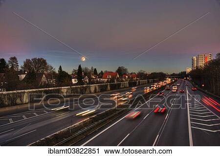 Stock Image - "A96 motorway at dusk with light trails of moving cars, Munich, Bavaria, Germany, Europe". Fotosearch