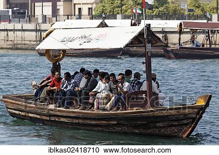 Stock Image - Abra, traditional water taxi on Dubai Creek, between Deira and Bur Dubai, Dubai, United Arab Emirates, Middle East, Asia. Fotosearch