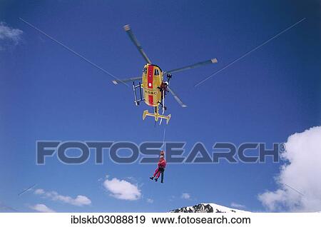 "ADAC helicopter during a mountain rescue with a winch, Spitzingsee, Schliersee, Upper Bavaria, Bavaria, Germany, Europe" View Large Photo Image Stock Photo - "ADAC helicopter during a mountain rescue with a winch, Spitzingsee, Schliersee, Upper Bavaria, Bavaria, Germany, Europe". Fotosearch