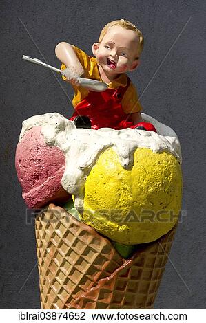 Stock Image - "Advertising character in front of an ice cream shop, a young boy in a giant ice cream cone, Wasserburg am Inn, Upper Bavaria, Bavaria, Germany, Europe". Fotosearch