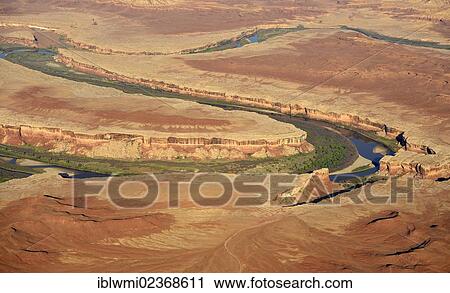 Stock Image - "Aerial view, bend of the Green River, The White Rim, Island in the Sky, Canyonlands National Park, Utah, United States of America, USA". Fotosearch