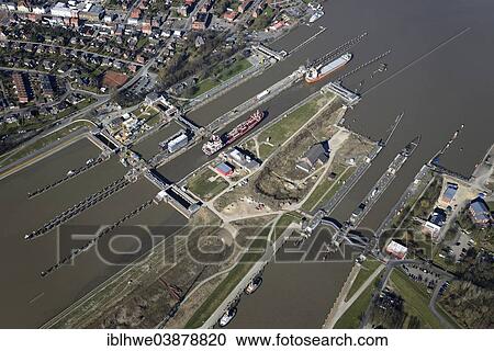 "Aerial view, canal lock at Brunsbuttel, Kiel Canal or Nord-Ostsee-Kanal, preparatory construction works for new lock gates during full lock operation, Brunsbuttel, Schleswig-Holstein, Germany, Europe" View Large Photo Image Stock Image - "Aerial view, canal lock at Brunsbuttel, Kiel Canal or Nord-Ostsee-Kanal, preparatory construction works for new lock gates during full lock operation, Brunsbuttel, Schleswig-Holstein, Germany, Europe". Fotosearch