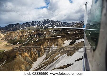 "Aerial view, Cessna airplane, rhyolite mountains partially covered with snow, Landmannalaugar, Fjallabak conservation area, Icelandic Highlands, Iceland, Europe" View Large Photo Image Stock Image - "Aerial view, Cessna airplane, rhyolite mountains partially covered with snow, Landmannalaugar, Fjallabak conservation area, Icelandic Highlands, Iceland, Europe". Fotosearch