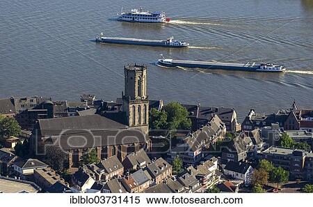 "Aerial view, church of St. Aldegundis with cargo ships on the Rhine, Emmerich am Rhein, North Rhine-Westphalia, Germany, Europe" View Large Photo Image Stock Photography - "Aerial view, church of St. Aldegundis with cargo ships on the Rhine, Emmerich am Rhein, North Rhine-Westphalia, Germany, Europe". Fotosearch