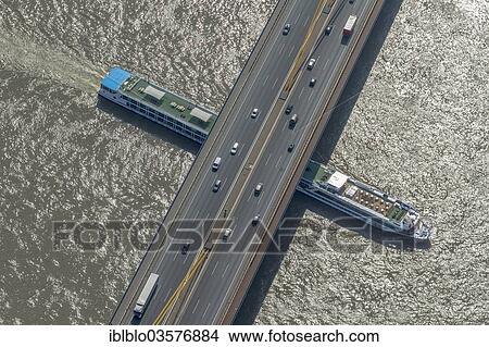 Picture - "Aerial view, cruise ship on the Rhine underneath the Rhine bridge of motorway A42, Duisburg, Ruhr district, North Rhine-Westphalia, Germany, Europe". Fotosearch