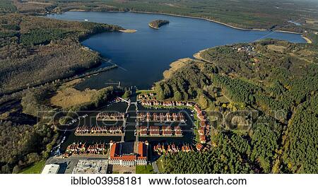 Stock Image - "Aerial view, holiday homes with moorings, Rheinsberg Marina, Rheinsberg Harbour Village, Maritim Hafenhotel Rheinsberg, Grosser Rheinsberger See Lake, Rheinsberg, Mecklenburg Lake District, Brandenburg, Germany, Europe". Fotosearch