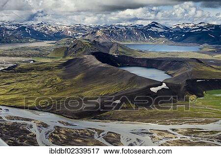Stock Photo - "Aerial view, Ljotipollur Crater Lake, rhyolite mountains partially covered with snow, Tungnaa braided river, Landmannalaugar, Fjallabak conservation area, Icelandic Highlands, Iceland, Europe". Fotosearch