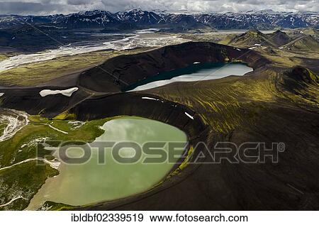 Stock Photo - "Aerial view, Ljotipollur Crater Lake, Lake Blautaver, rhyolite mountains partially covered with snow, Landmannalaugar, Fjallabak conservation area, Icelandic Highlands, Iceland, Europe". Fotosearch