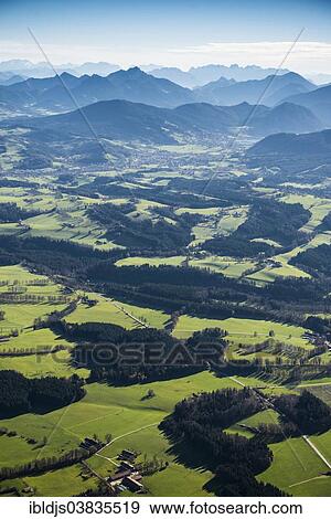 Stock Photo - "Aerial view, meadows, forests and Alps, near Tegernsee, Upper Bavaria, Bavaria, Germany, Europe". Fotosearch