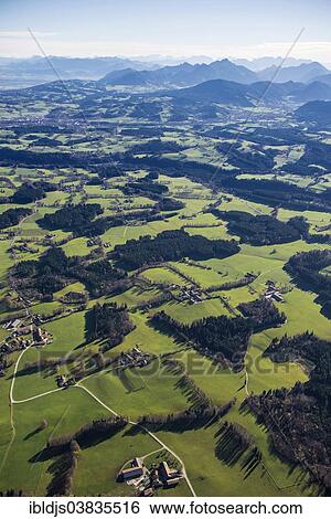 Stock Photograph - "Aerial view, meadows, forests and Alps, near Tegernsee, Upper Bavaria, Bavaria, Germany, Europe". Fotosearch