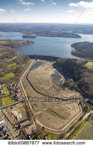 Stock Photo - "Aerial view, Mohnesee dam with an empty basin in front of the dam, Sauerland, North Rhine-Westphalia, Germany, Europe". Fotosearch