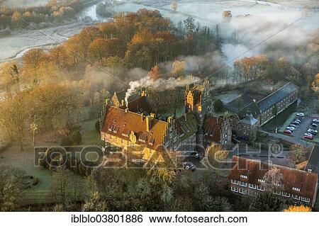 Stock Photograph - "Aerial view, morning mist, Schloss Heessen castle boarding school, Hamm, Ruhr area, North Rhine-Westphalia, Germany, Europe". Fotosearch