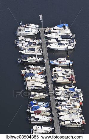 Stock Photography - "Aerial view, motor boats at a jetty on the Dove-Elbe, an anabranch of the Unterelbe River, Hamburg, Hamburg, Germany, Europe". Fotosearch