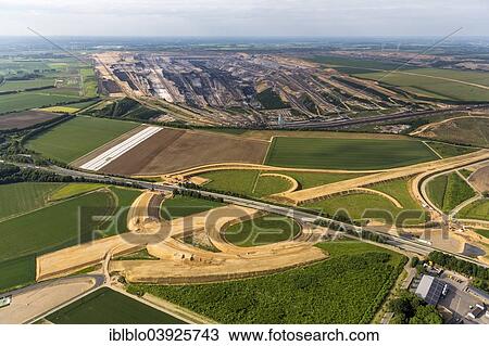 Stock Image - "Aerial view, new motorway junction A61 and A44 and Garzweiler surface mine I, Bedburg, Lower Rhine, North Rhine-Westphalia, Germany, Europe". Fotosearch