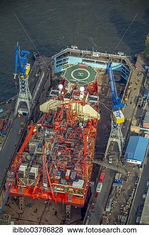 "Aerial view, oil drilling vessel anchored in the roadstead, Petrojarl Banff, Blohm + Voss shipyard, port of Hamburg, Hamburg, Germany, Europe" View Large Photo Image Stock Photo - "Aerial view, oil drilling vessel anchored in the roadstead, Petrojarl Banff, Blohm + Voss shipyard, port of Hamburg, Hamburg, Germany, Europe". Fotosearch