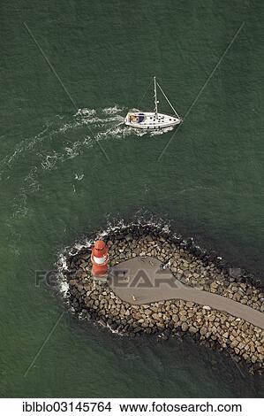 "Aerial view, port side, Molenfeuer Warnemuende lighthouse with a sailboat, Warnemunde, Rostock, Mecklenburg-Western Pomerania, Germany, Europe" View Large Photo Image Picture - "Aerial view, port side, Molenfeuer Warnemuende lighthouse with a sailboat, Warnemunde, Rostock, Mecklenburg-Western Pomerania, Germany, Europe". Fotosearch