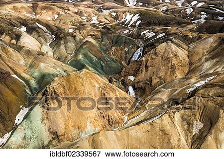 Stock Photo - "Aerial view, rhyolite mountains partially covered with snow, Landmannalaugar, Fjallabak conservation area, Icelandic Highlands, Iceland, Europe". Fotosearch