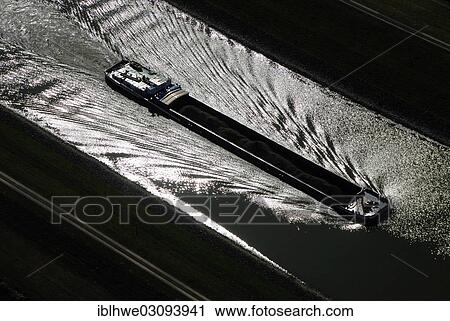 Stock Image - "Aerial view, riverboat used for bulk cargo transport on the Elbe River, Lueneburg, Lower Saxony, Germany, Europe". Fotosearch
