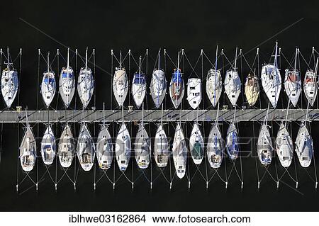 "Aerial view, sailing boats moored at a jetty, Grossenbrode, Schleswig-Holstein, Germany, Europe" View Large Photo Image Picture - "Aerial view, sailing boats moored at a jetty, Grossenbrode, Schleswig-Holstein, Germany, Europe". Fotosearch