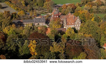 Stock Image - "Aerial view, Schloss Heessen, a moated castle used as a boarding school, in autumn, Hamm, Ruhr area, North Rhine-Westphalia, Germany, Europe". Fotosearch