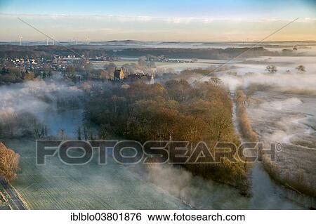 Stock Photograph - "Aerial view, Schloss Heessen castle boarding school, morning fog over the Lippe river, Hamm-Heessen, Hamm, Ruhr area, North Rhine-Westphalia, Germany, Europe". Fotosearch