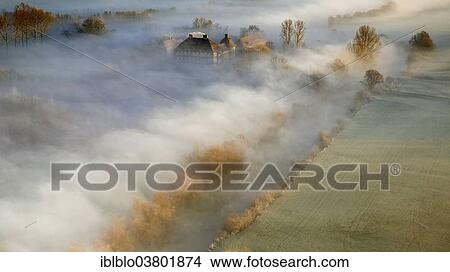 Picture - "Aerial view, Schloss Oberwerries moated castle, morning mist above the Lippe river, Lippeauen, Hamm, Ruhr area, North Rhine-Westphalia, Germany, Europe". Fotosearch