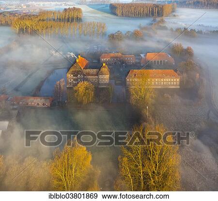 Stock Photo - "Aerial view, Schloss Oberwerries moated castle, morning mist above the Lippe river, Lippeauen, Hamm, Ruhr area, North Rhine-Westphalia, Germany, Europe". Fotosearch