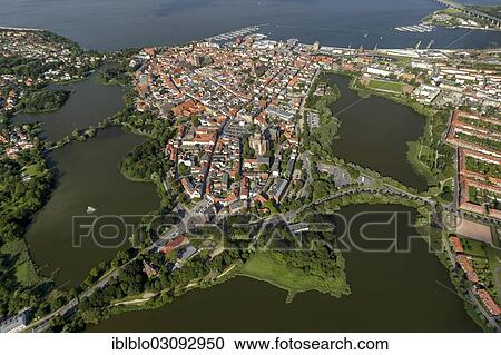 Stock Image - "Aerial view, Stralsund, with the old town island surrounded by water at the sound of Strelasund, Baltic Sea, Stralsund, Mecklenburg-Western Pomerania, Germany, Europe". Fotosearch