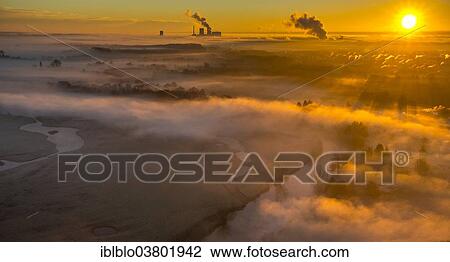 Stock Image - "Aerial view, sunrise, morning mist above the Lippe river, gas turbine power plant Trianel power plant, Hamm, Ruhr area, North Rhine-Westphalia, Germany, Europe". Fotosearch