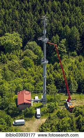 Stock Photo - "Aerial view, technicians working on a radio mast, Bad Laasphe, North Rhine-Westphalia, Germany, Europe". Fotosearch
