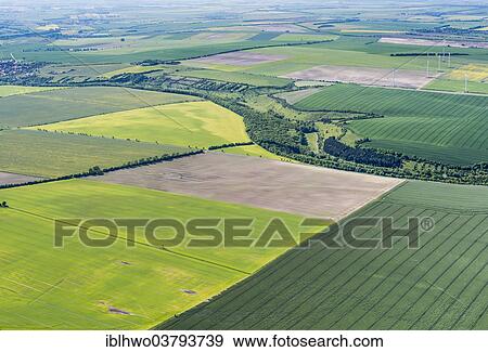 Stock Photo - "Aerial view, Thuringian Basin, flat landscape with fields, crossed by the River Unstrut, Doellstaedt, Thuringia, Germany, Europe". Fotosearch