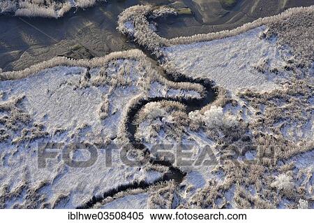 Stock Photography - "Aerial view, tidal creek in freshwater mud flats in winter, Heuckenlock Nature Reserve, Moorwerder, Hamburg, Hamburg, Germany, Europe". Fotosearch