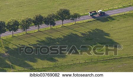 "Aerial view, tractor travelling on a country road, North Rhine-Westphalia, Germany, Europe" View Large Photo Image Stock Image - "Aerial view, tractor travelling on a country road, North Rhine-Westphalia, Germany, Europe". Fotosearch