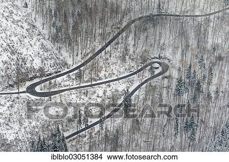Picture - "Aerial view, winding forest road in winter, Beringhausen, Meschede, North Rhine-Westphalia, Germany, Europe". Fotosearch
