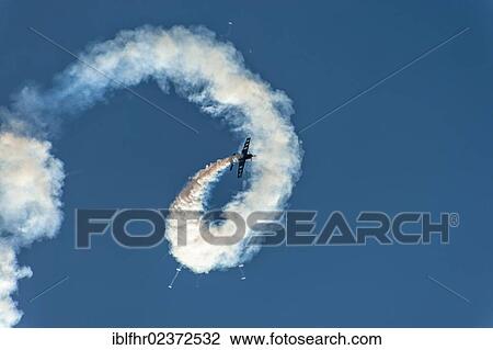 "Aerobatic flight with an Extra 300S aircraft with smoke in the blue sky, Grevenbroich, North Rhine-Westphalia, Germany, Europe" View Large Photo Image Stock Image - "Aerobatic flight with an Extra 300S aircraft with smoke in the blue sky, Grevenbroich, North Rhine-Westphalia, Germany, Europe". Fotosearch