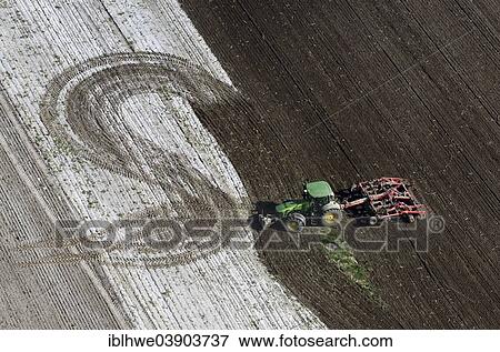 Stock Photo - "Agricultural work with acultivator, aerial view, Schleswig-Holstein, Germany, Europe". Fotosearch
