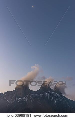 Stock Image - "Aiguilles d'Arves mountain at dawn with the moon, Pelvoux, Dauphine Alps, Savoie, France, Europe". Fotosearch