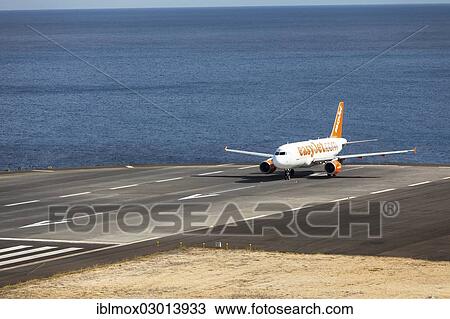 Stock Image - "Airbus from easyjet. com preparing for takeoff at Madeira Airport, LPMA, also known as Funchal Airport and Santa Catarina Airport, Santa Catarina, Funchal, Madeira, Portugal, Europe". Fotosearch