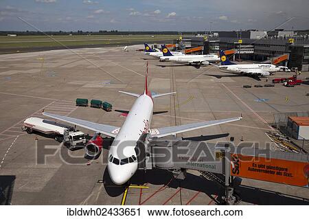"Airplane attached to a jetway or passenger boarding bridge on the airport apron, Duesseldorf International Airport, Duesseldorf, North Rhine-Westphalia, Germany, Europe" View Large Photo Image Stock Image - "Airplane attached to a jetway or passenger boarding bridge on the airport apron, Duesseldorf International Airport, Duesseldorf, North Rhine-Westphalia, Germany, Europe". Fotosearch