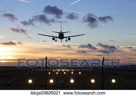 "Airplane during the landing approach, crosswind runway with position lights, runway of Cologne-Bonn Airport at sunset, Cologne, North Rhine-Westphalia, Germany, Europe" View Large Photo Image Stock Image - "Airplane during the landing approach, crosswind runway with position lights, runway of Cologne-Bonn Airport at sunset, Cologne, North Rhine-Westphalia, Germany, Europe". Fotosearch