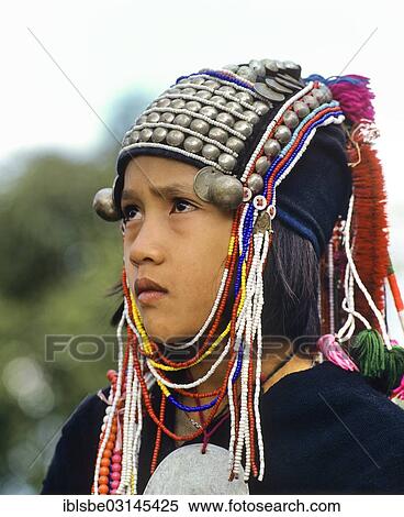 Stock Photography - "Akha girl with traditional clothing and headdress, portrait, Chiang Rai Province, Northern Thailand, Thailand, Asia". Fotosearch