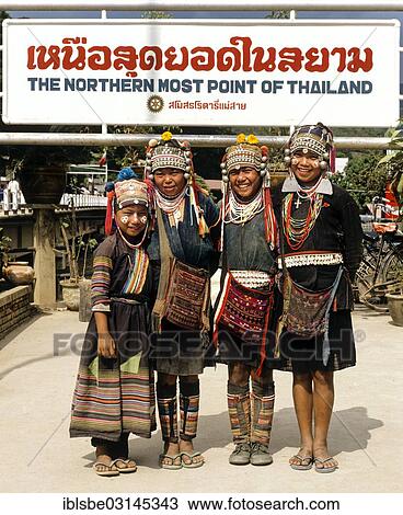 Stock Image - "Akha hill tribe girls wearing traditional costumes and headdresses standing at the northernmost point of Thailand, Mae Sai, Chiang Rai Province, Northern Thailand, Thailand, Asia". Fotosearch