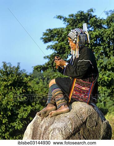 "Akha woman in a mountain village, in traditional costume and headdress with silver bells, Chiang Rai Province, Northern Thailand, Thailand, Asia" View Large Photo Image Stock Image - "Akha woman in a mountain village, in traditional costume and headdress with silver bells, Chiang Rai Province, Northern Thailand, Thailand, Asia". Fotosearch