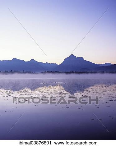 "Allgau Alps reflected in Hopfensee lake, Ostallgau, Allgau, Upper Bavaria, Bavaria, Germany, Europe" View Large Photo Image Stock Image - "Allgau Alps reflected in Hopfensee lake, Ostallgau, Allgau, Upper Bavaria, Bavaria, Germany, Europe". Fotosearch