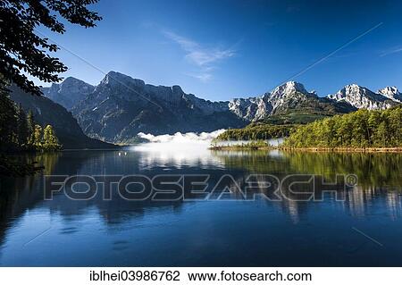 "Almsee lake in autumn, Zehnerkogel, Elferkogel, Zwolferkogel, Einserkogel, Grosser Woising, Kleiner Woising, Totes Gebirge mountains, Almtal valley, Upper Austria, Austria, Europe" View Large Photo Image Stock Image - "Almsee lake in autumn, Zehnerkogel, Elferkogel, Zwolferkogel, Einserkogel, Grosser Woising, Kleiner Woising, Totes Gebirge mountains, Almtal valley, Upper Austria, Austria, Europe". Fotosearch