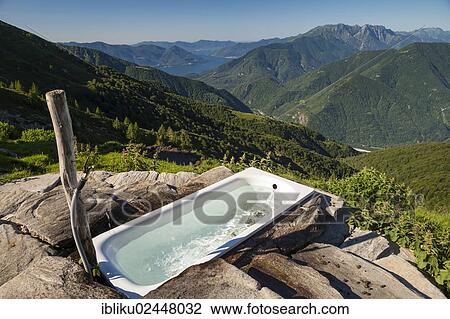 "Alpe Nimi Mountain with a bathtub with a view towards the Alps, Valle Maggia, overlooking Lake Maggiore, Ticino, Switzerland, Europe" View Large Photo Image Stock Image - "Alpe Nimi Mountain with a bathtub with a view towards the Alps, Valle Maggia, overlooking Lake Maggiore, Ticino, Switzerland, Europe". Fotosearch