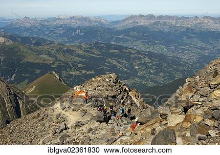 Stock Image - "Alpinists during the ascent of Mont Blanc along the regular route via Gouter Hut, information tent at about 3100 meters above sea level near the Tete Rousse Hut, at the rear, Chamonix, France, Europe". Fotosearch